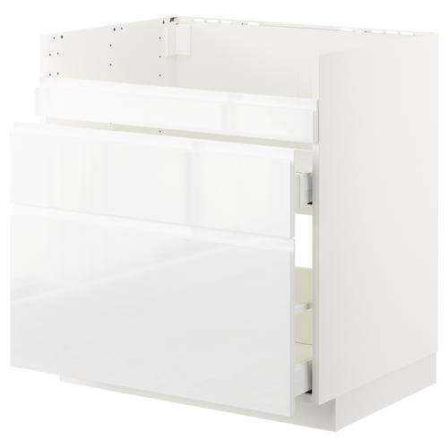 Bílá moderní kuchyňská skříňka, elegantní design s několika zásuvkami a policemi, vyrobená z dřevotřísky a kovu.