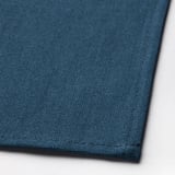 Detailní záběr na tmavě zeleno-modrou tkanou látku, která představuje vysoce kvalitní texturu a detail prošívání.