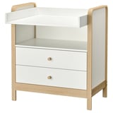 An ÄLSKVÄRD white and light wood changing table with two drawers. It has a simple, modern design with a flat top and curved guardrails.