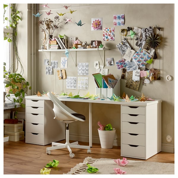Home office area with white ALEX drawers, desk, and chair. Decorated with origami and art.