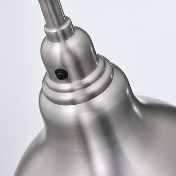 Close-up of a brushed metal lamp joint, showcasing a sleek, adjustable design. High-quality finish, durable construction.