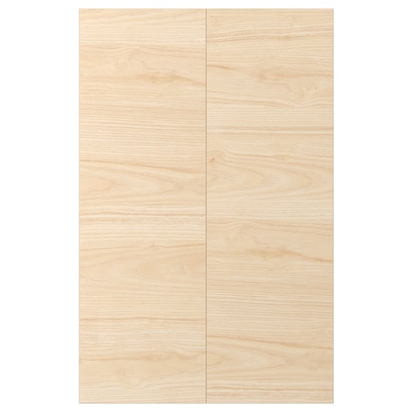 ASKERSUND cabinet doors with a light ash wood design and a blurred texture, made of melamine and particleboard.