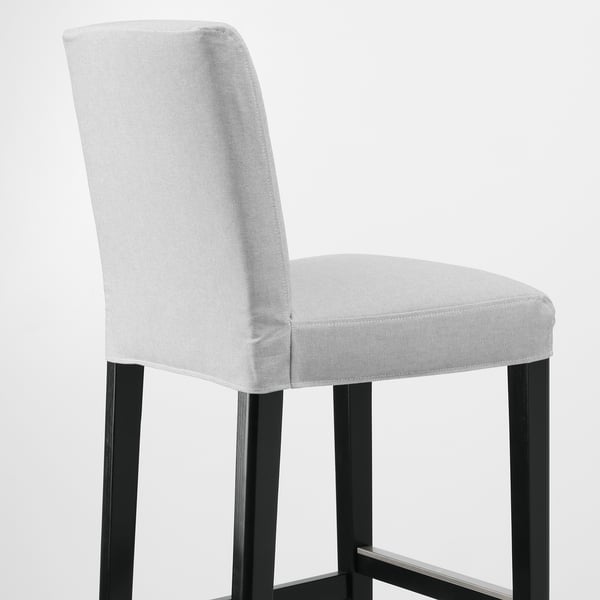 Modern bar stool with sleek black legs and plush, removable grey fabric for comfort.