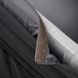 Close-up of black velvet chair cover, soft, removable, washable, with stitching detail.