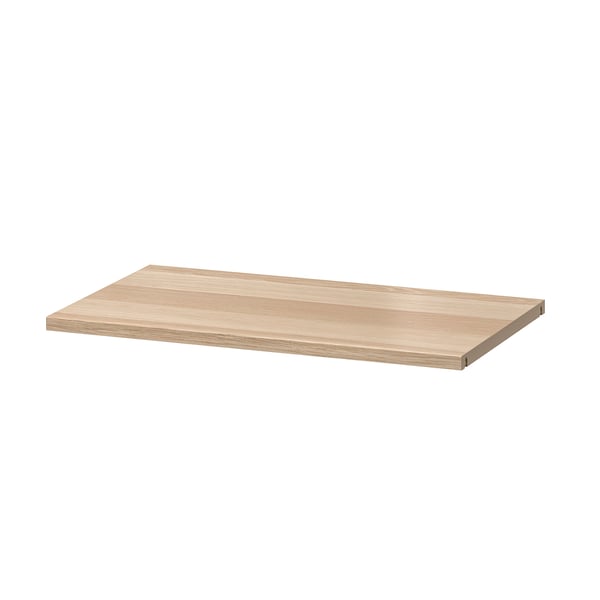 An ikea BESTÅ wooden shelf, light brown, rectangular, flat, and simple in design.