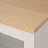 Close-up of modern furniture. Light wood top with smooth finish, clean white base, sleek design.