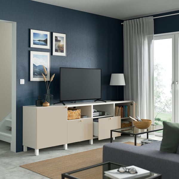 Modern living room with BESTÅ tv unit, flat screen, storage, shelves, decor, and large window.