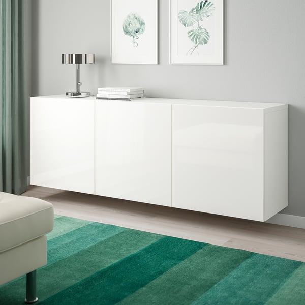 BESTÅ wall-mounted cabinet combo, modern design, saves floor space, with minimalist handles, lamp, books, and botanical prints.