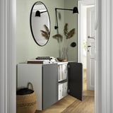 Modern wall-mounted cabinet, open showing storage, books, and basket. Airy design.