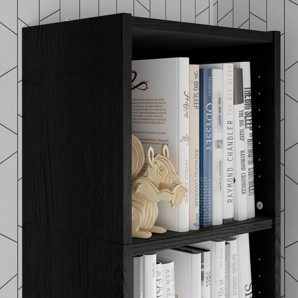 Black bookshelf with wooden toy and books, maximizing vertical storage.