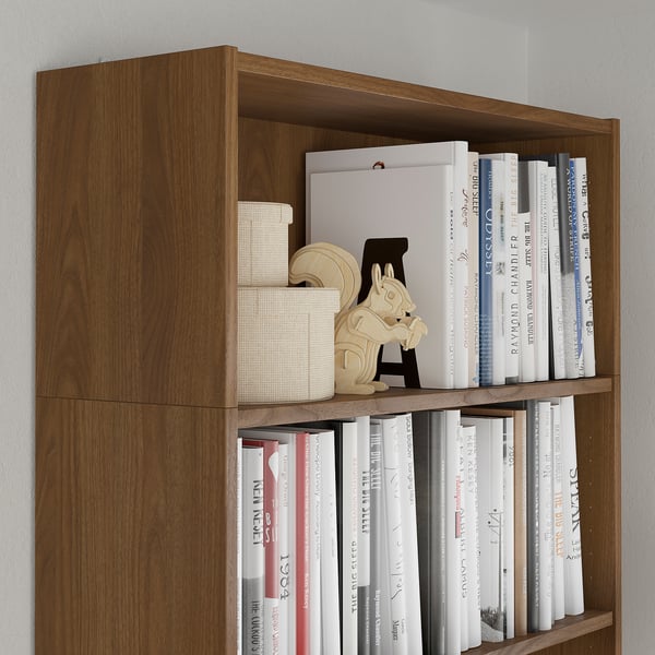 Wooden bookshelf with multiple shelves filled with books, including a unique wooden bookend shaped like a horse.