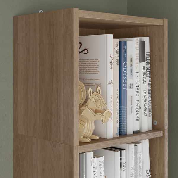 Wooden bookshelf with multiple shelves displaying various books.