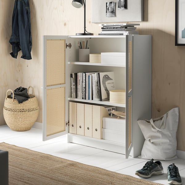 Cozy room with white BILLY bookcase, bamboo doors, and natural decor.