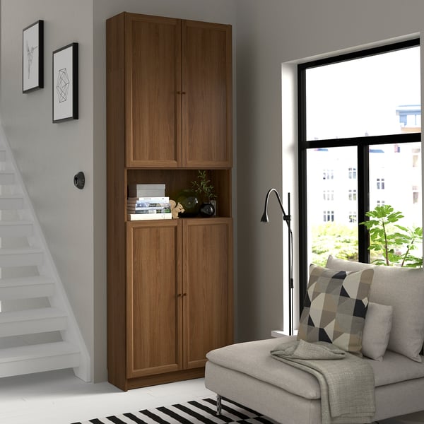 Modern living room with BILLY bookcase, grey sofa, and large window.