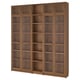 A BILLY bookcase in oak color, made of particleboard and glass, featuring multiple shelves and clear glass doors.