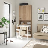 Modern home office setup: white desk, light wood BILLY bookcase, white swivel chair, potted plant, beige sofa with polka dot pillow, and wall art.