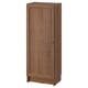An upright BILLY bookcase, a wooden storage cabinet with a single door, featuring a natural, warm brown finish.