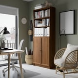 Home office with BILLY bookcase, green walls.