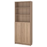 BILLY bookcase: tall, light brown, wooden, rectangular with open and closed storage.