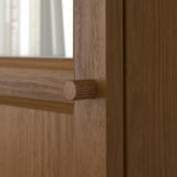 Close-up of wooden door hinge; shows high-quality craftsmanship, smooth finish, and sturdy construction.