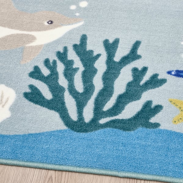 Underwater-themed childs rug with coral design, soft and durable texture.