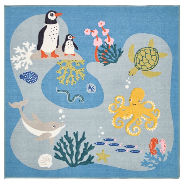 Depicts a square, blue childrens rug, the BLÅVINGAD, with a playful underwater design including penguins, turtles, octopus, whale, fish, and coral.