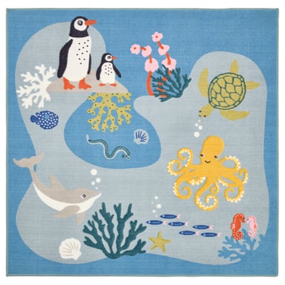 Depicts a square, blue childrens rug, the BLÅVINGAD, with a playful underwater design including penguins, turtles, octopus, whale, fish, and coral.