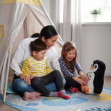 Family plays on BLÅVINGAD underwater rug, enhancing imaginative play and comfort for kids.