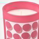 Bright pink candle in glass with polka dots. Elegant and playful, it fills the room with a warm, strawberry-vanilla scent.