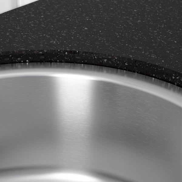 Stainless steel sink with granulated countertop, showcasing high-quality craftsmanship.