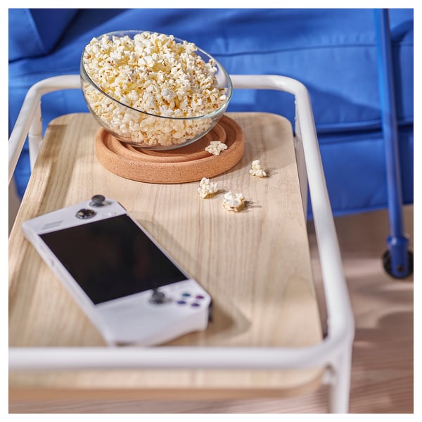 Wooden side table with popcorn & gaming device.