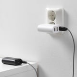 Wall-mounted charger with two usb ports powers a corded device, ensuring a backup power source.