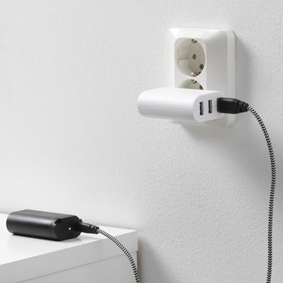 Wall-mounted charger with two usb ports powers a corded device, ensuring a backup power source.
