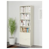 Bookshelf with adjustable shelves and drawers, anchored to wall, perfect for organizing books and hidden storage.