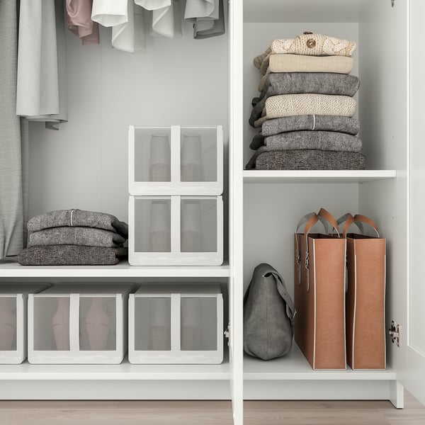 Well-organized closet with shelves for folded clothes, boxes for accessories, and hooks for hanging garments. Includes safety fitting.