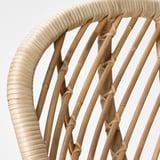 Handwoven rattan armchair, showcasing intricate weave and natural texture, highlighting craftsmanship and durability.
