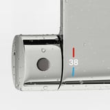 Silver shower control panel with temperature indicators. Red for hot, blue for cold, and 38 safety stop mark.