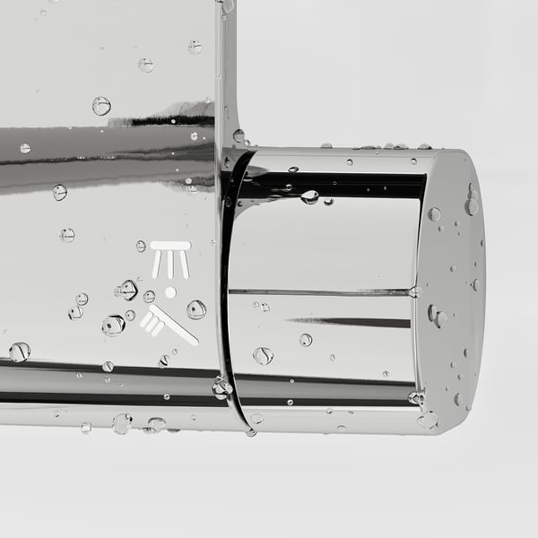 Stainless steel shower mixer with full spray hand shower, droplets on surfaces.