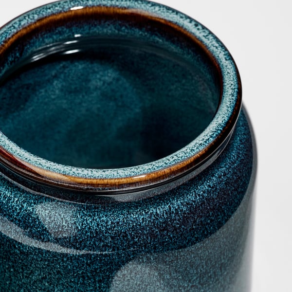 Rustic glazed blue jar with cork lid.