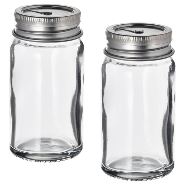 Two empty CITRONHAJ spice jars with silver lids, standing side by side, clear glass, cylindrical shape, simple design.