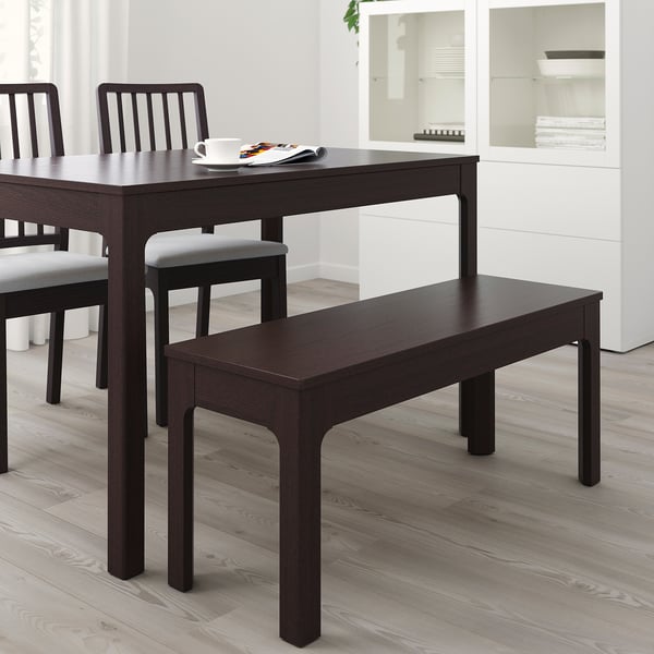 Dark brown EKEDALEN bench fits under table, minimalist design, matches dining set.
