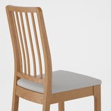 Hardwood chair with slatted back, upholstered seat, light-colored fabric, sturdy, wooden frame