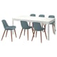 A white rectangular dining table with six blue chairs. Table has a sleek flat top and legs. Chairs have blue plastic seats and wooden legs.