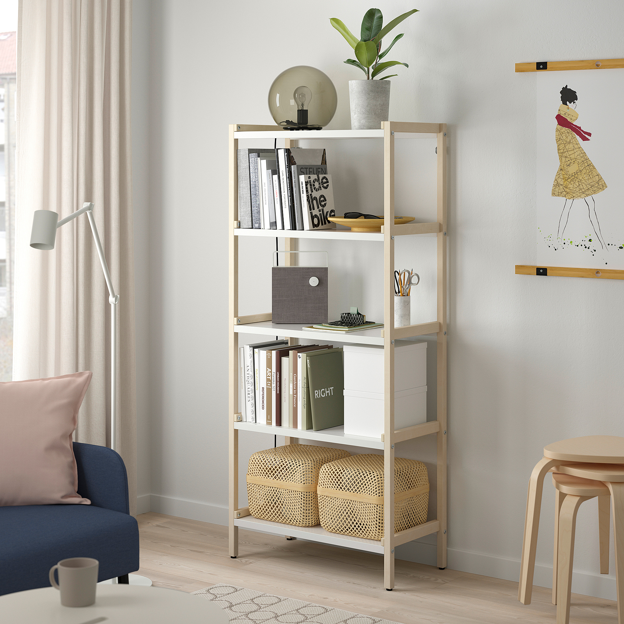 EKENABBEN light wood bookshelf holds books, decor & storage baskets, placed between sofa and wall, topped with a lamp.