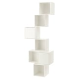 A white, wall-mounted EKET storage unit with multiple compartments. It has a modern, minimalist design with asymmetric, staggered shelves.