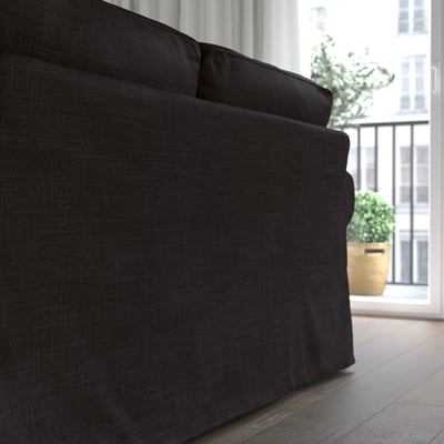 Dark gray EKTORP sofa, plush cushions, near large window and plant.