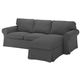 Dark grey EKTORP sectional sofa with rolled arms and plush cushions, modern yet classic design.