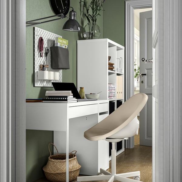 Modern white home office setup with a stylish, adjustable desk chair, sleek desk, and organized wall storage.