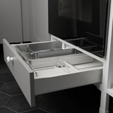 White kitchen drawer with silver trays, designed for oven storage. Part of the ENHET series, it a ¾ drawer extension for easy access.
