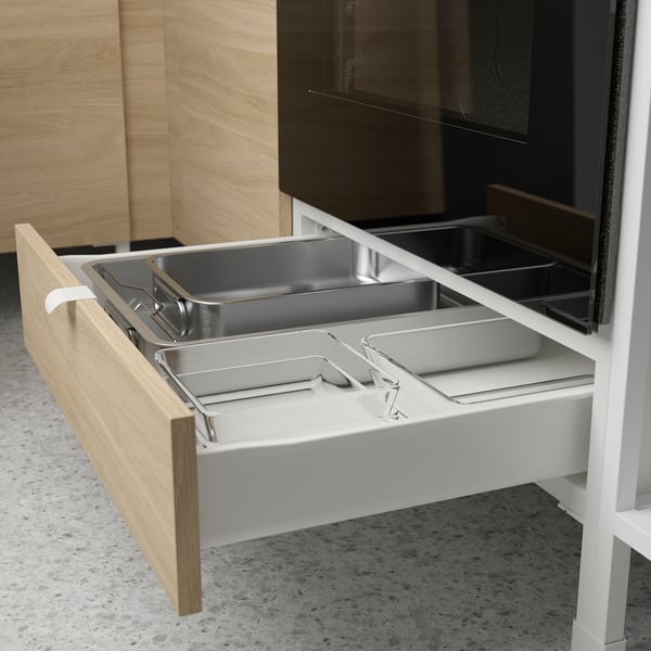 Open kitchen drawer with stainless steel trays, oak effect front.